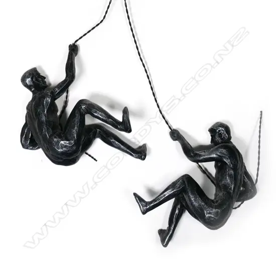A pair of climbing men statuettes.