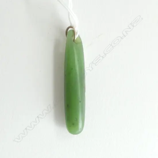 An old Māori pounamu kuru (pendant) stone tooled,