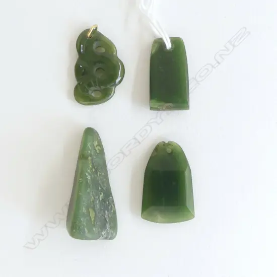 Four small pounamu Māori design carvings