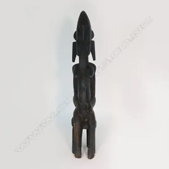 An African carved hardwood seated ancestral figure