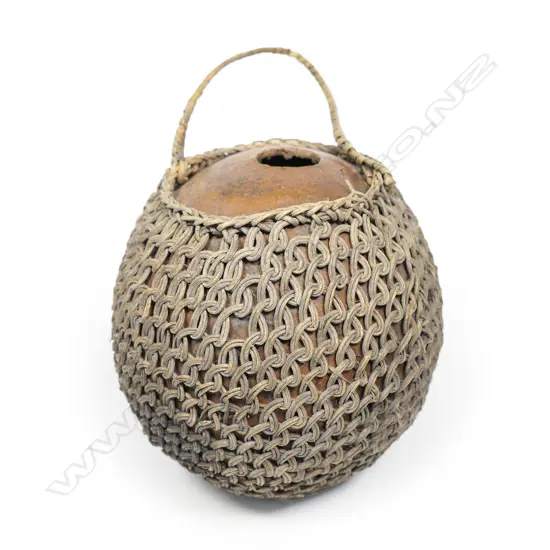 A vintage woven fibre covered coconut shell water flask,