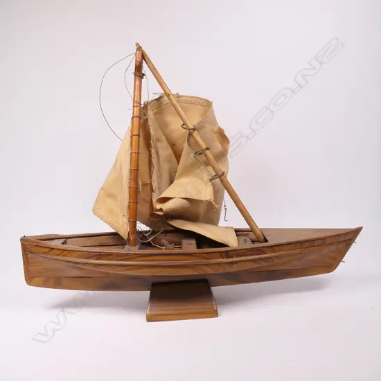 A vintage Pitcairn Island craved wooden long boat on stand,
