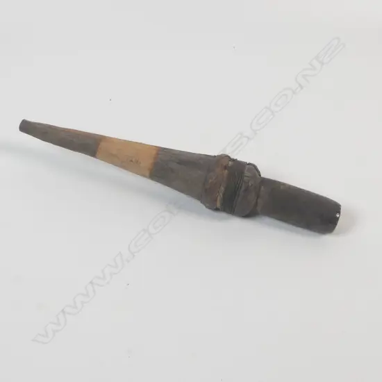 A hafted stone sago pounder,