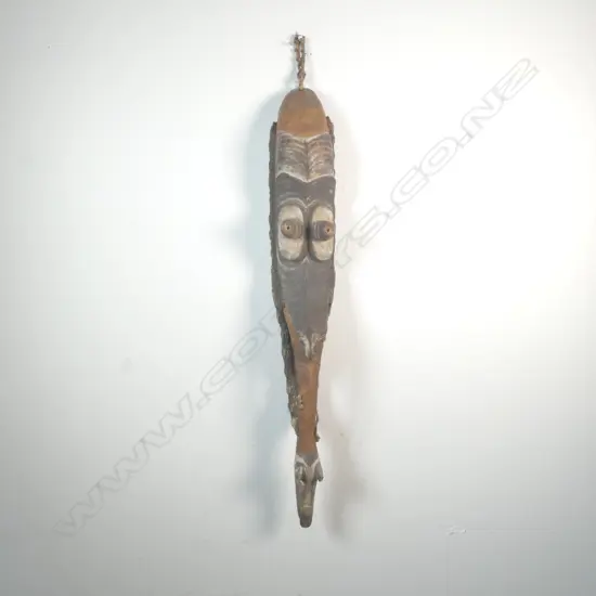A Papua New Guinea mask in wood and cowrie shell,
