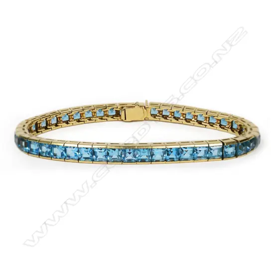 An 18ct gold and blue topaz tennis bracelet,
