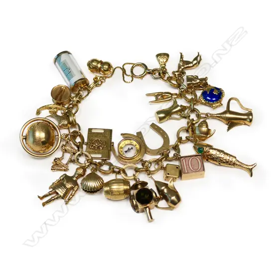 An impressive 26 gold charm 9ct gold charm bracelet,