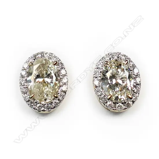 A pair of 14ct gold diamond halo stud earrings,
