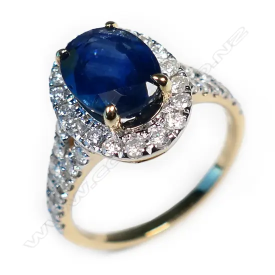A 14ct gold sapphire and diamond halo ring,