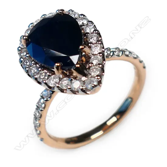 A 14ct rose gold, sapphire and diamond halo ring,