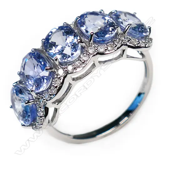 A 14ct white gold, Ceylonese sapphire and diamond halo ring,
