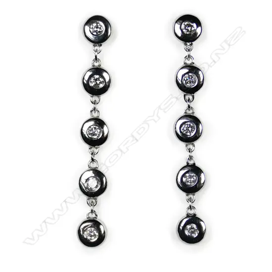 A pair of 9ct white gold and diamond drop earrings,