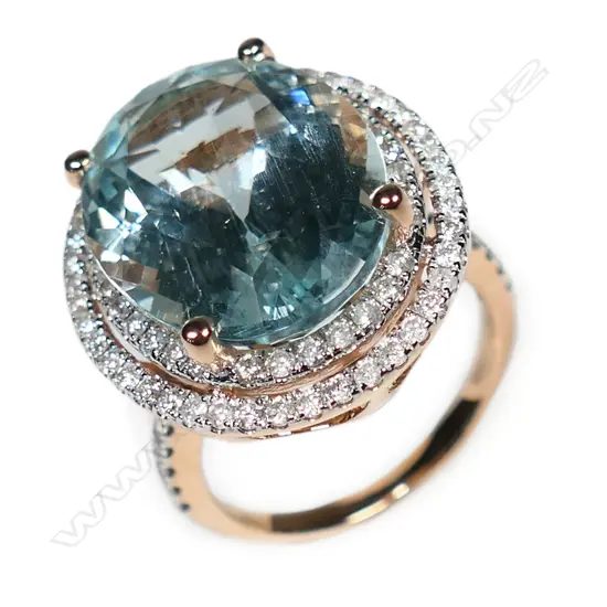 A 14ct rose gold aquamarine and diamond double halo ring,