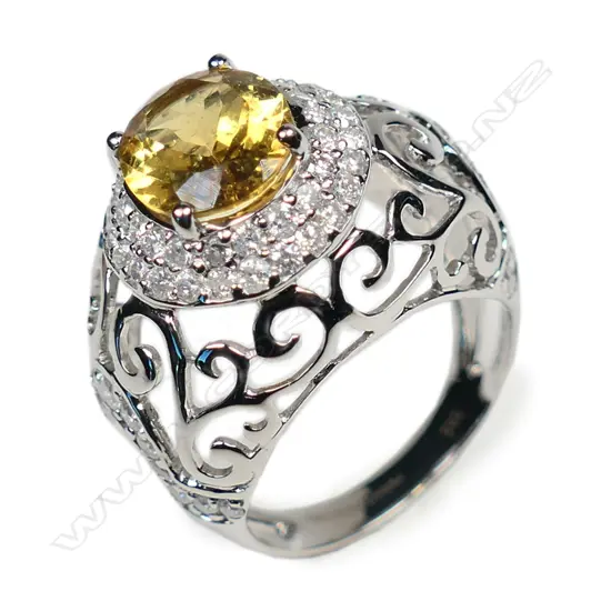 A 14ct white gold heliodor and diamond halo ring,