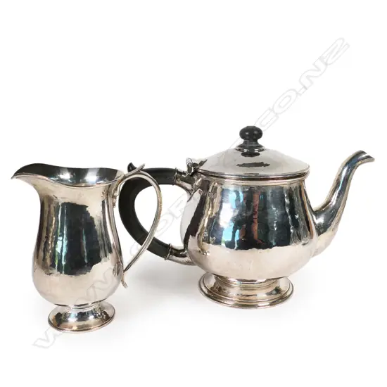 #A Guild of Handicraft Arts & Crafts style silver teapot and matching cream jug by George Hart