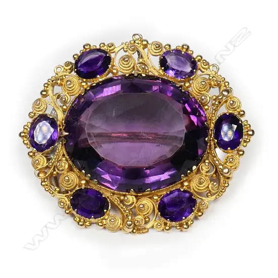 An impressive 22ct gold and amethyst brooch,