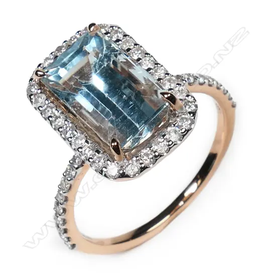 A 14ct rose gold aquamarine and diamond halo ring,
