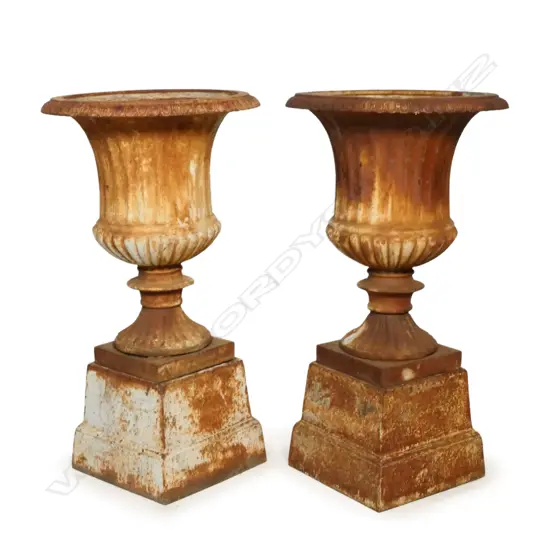 A pair of vintage cast iron garden urns,