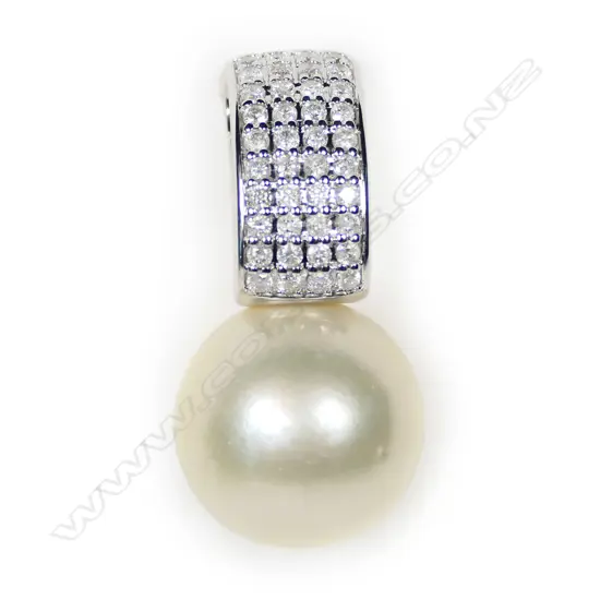 A 14ct white gold pearl and diamond pendant,