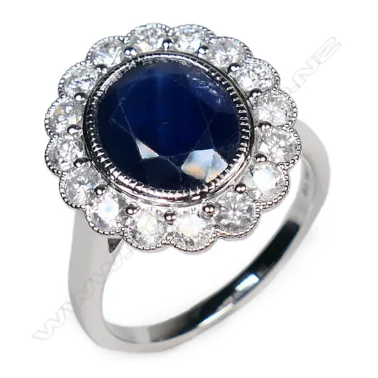 A 14ct white gold sapphire and diamond halo ring,