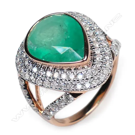 A 14ct rose gold emerald and diamond double halo ring,