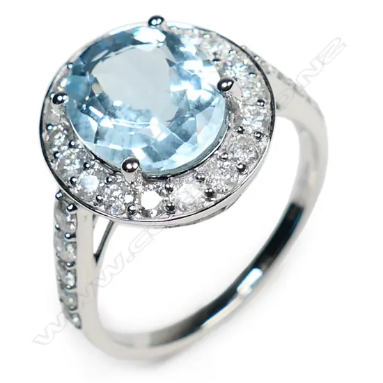 A 14ct white gold aquamarine and diamond halo ring,