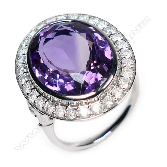 A 10ct white gold amethyst and diamond halo cocktail ring,