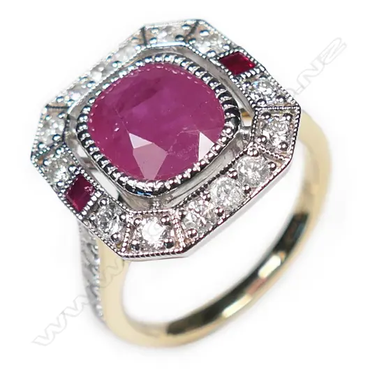 A 14ct gold ruby and diamond halo ring,