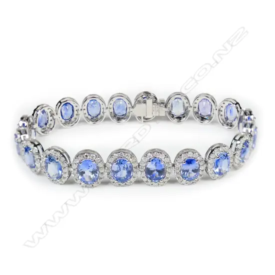 A 14ct white gold Ceylon sapphire and diamond halo bracelet,