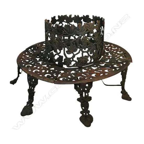 A 20thC Coalbrookdale style cast iron wrap around tree bench,