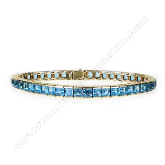 An 18ct gold and blue topaz tennis bracelet,