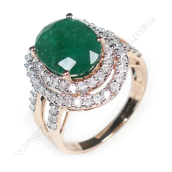 A 14ct rose gold emerald and diamond double halo ring,