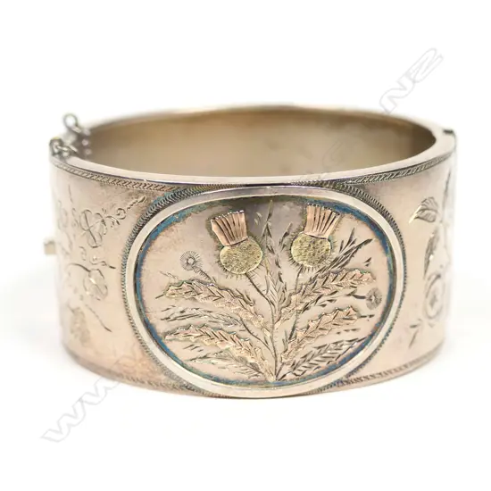 A 19thC colonial silver and rose gold fancy bangle,