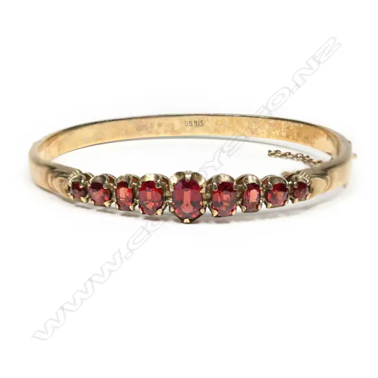 A vintage silver, gold plated garnet bangle,