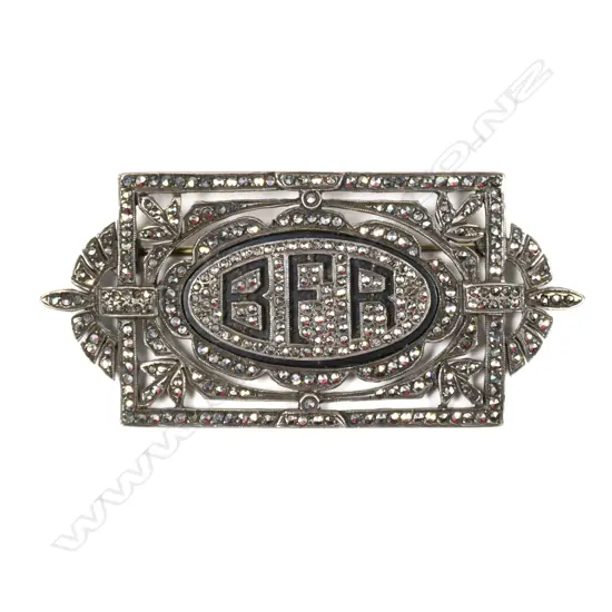 An Art Deco silver marcasite and enamel brooch