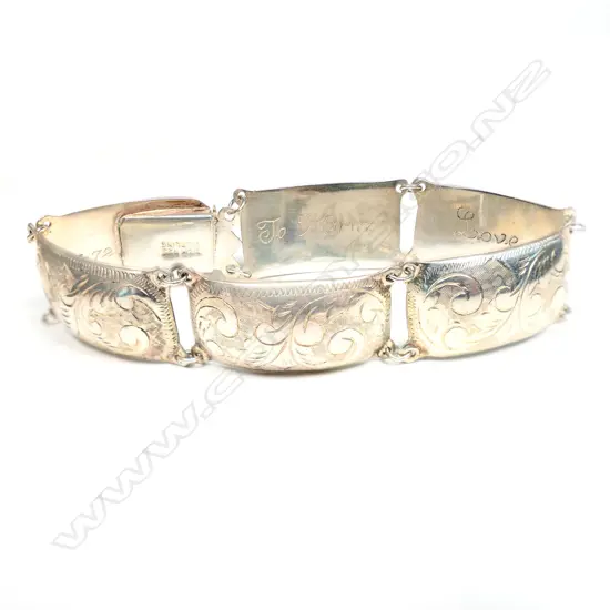 A silver hollow six panel bracelet,