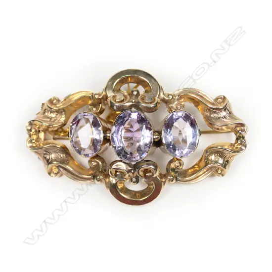A Victorian 9ct gold three amethyst brooch,