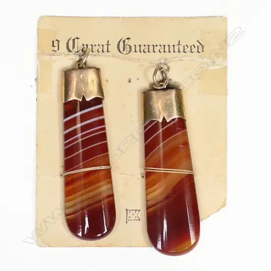 Two late Victorian 9ct gold capped striped agate pendants,