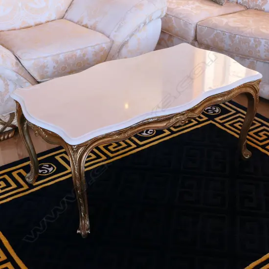 A white marble serpentine-top gilt wood coffee table