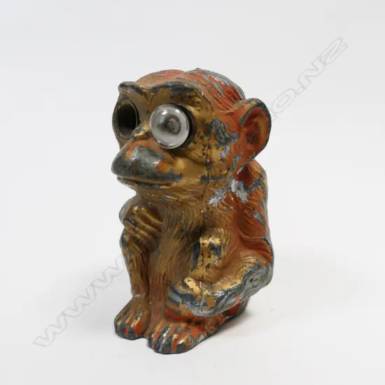Early 20thC monkey car mascot with electric bulb eye (one missing),