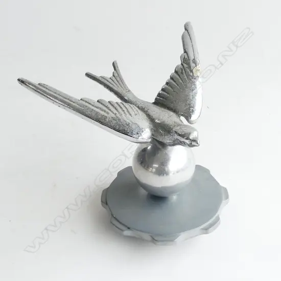 Chrome swallow bird on a ball car mascot,