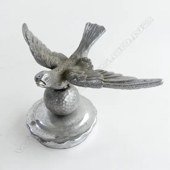 Chrome bird-on-golf ball car mascot,