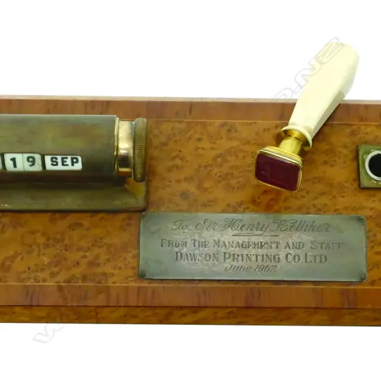 A 1960s burr totara and brass calendar/desk stand