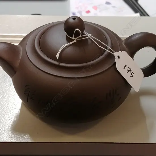A Chinese Yixing brown terracotta teapot