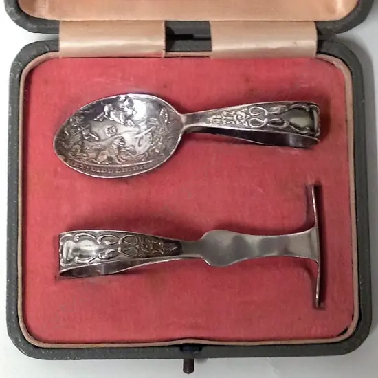 A silver child's spoon and pusher