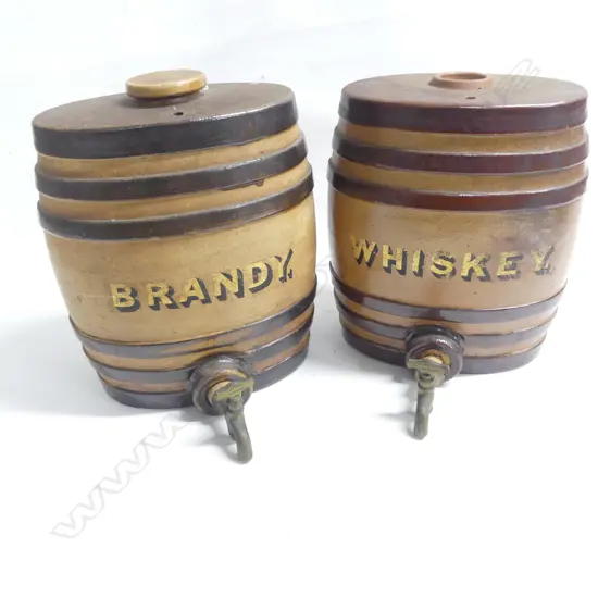 Two Victorian period stoneware spirit barrels: marked ‘Brandy’ and ‘Whisky’ in gilt lettering, brown glazed with three darker bands, both with brass taps, one retaining original stoneware top.  H.270mm