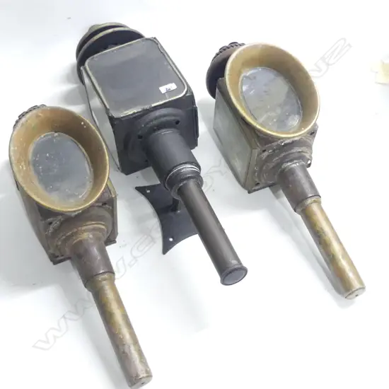 A pair of vintage gig lamps, steel with copper framed oval lenses; along with another black painted gig lamp. AF