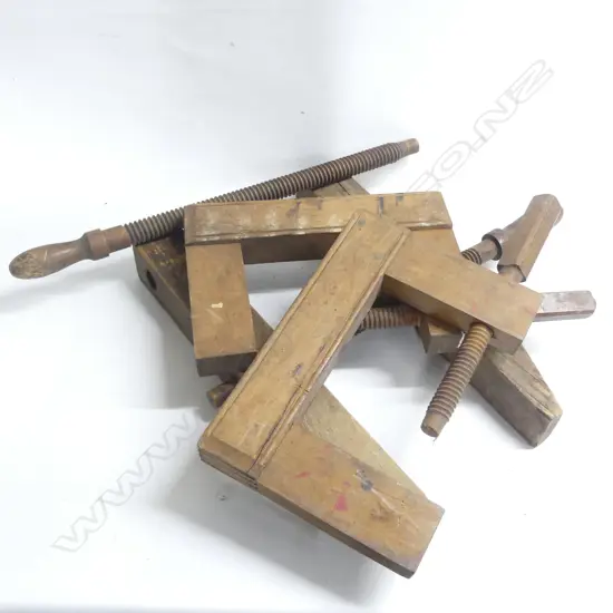 Two large wooden framed G-clamps along with a large wooden caliper clamp.