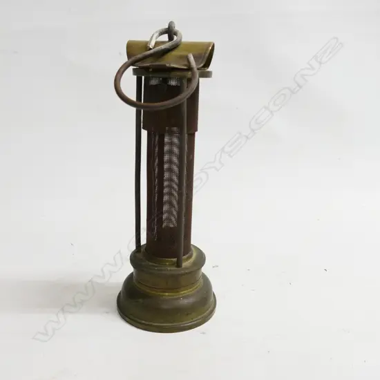 A Thomas & Williams brass miner's brass Safety Lamp c. 1900. The body being a long gauze section protected by three bars. H.235mm.