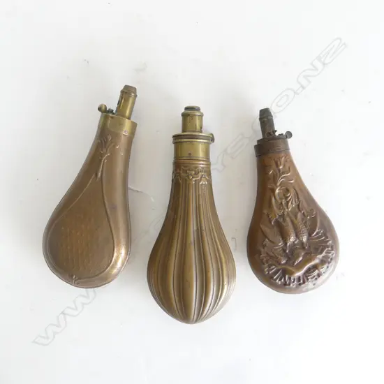 Three Victorian gunpowder flasks, with decoratively moulded bag shaped bodies.