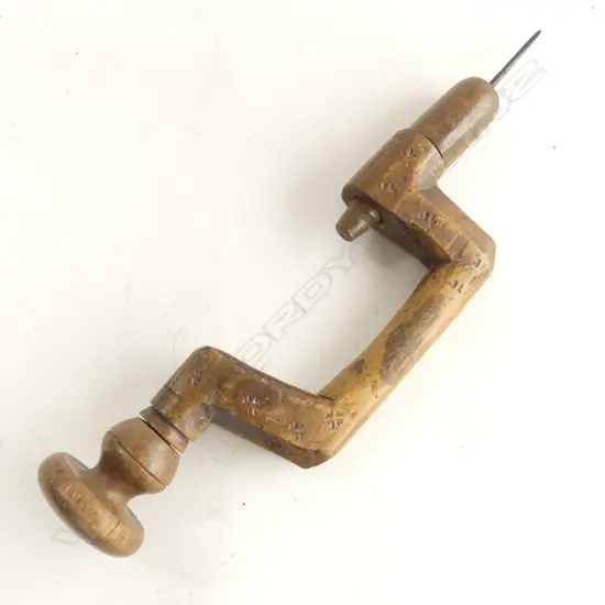 Totally wooden brace. Removeable wooden chuck with fitted bit. Unique reverse screw threads.